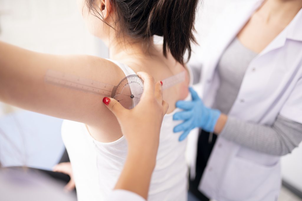 Female physiotherapist is examining to her patient.