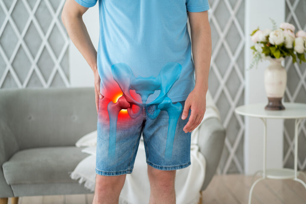 Hip dysplasia, joint inflammation, man suffering from pain at home, pelvic osteoarthritis
